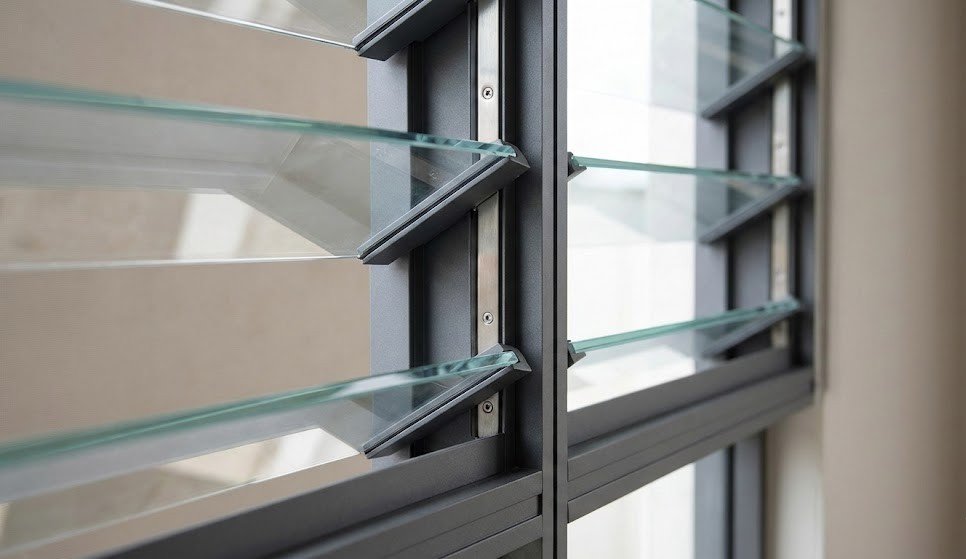 Close-up of aluminum jalousie window frame and glass louvers showing durable materials and precision construction.
